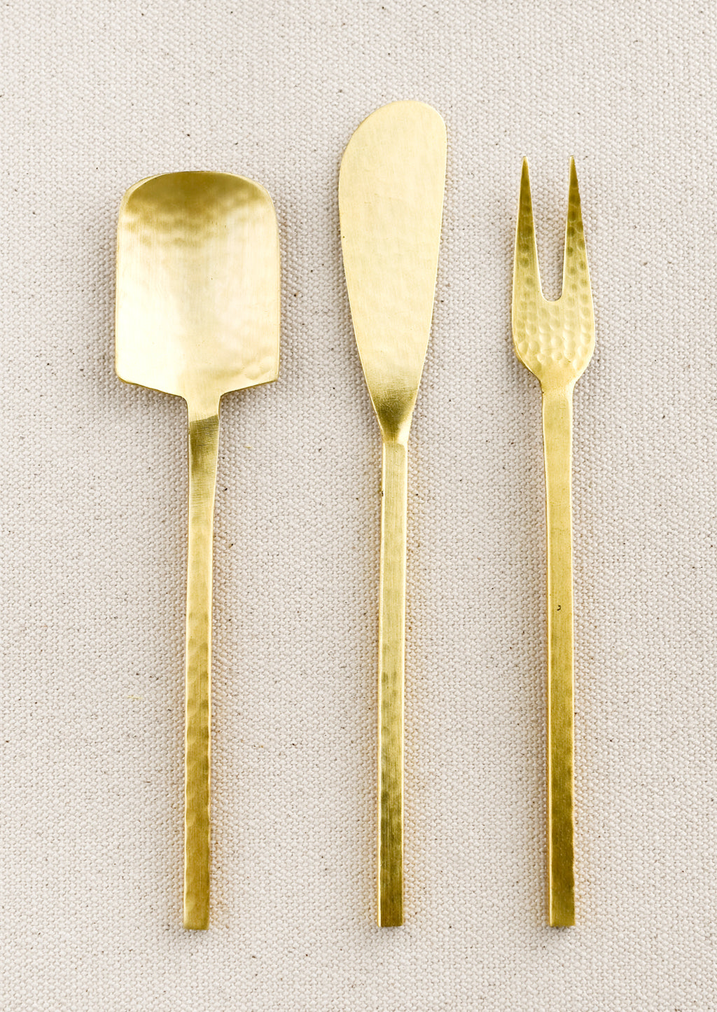 Knife: A spoon, fork and knife canape utensils in hammered gold finish.