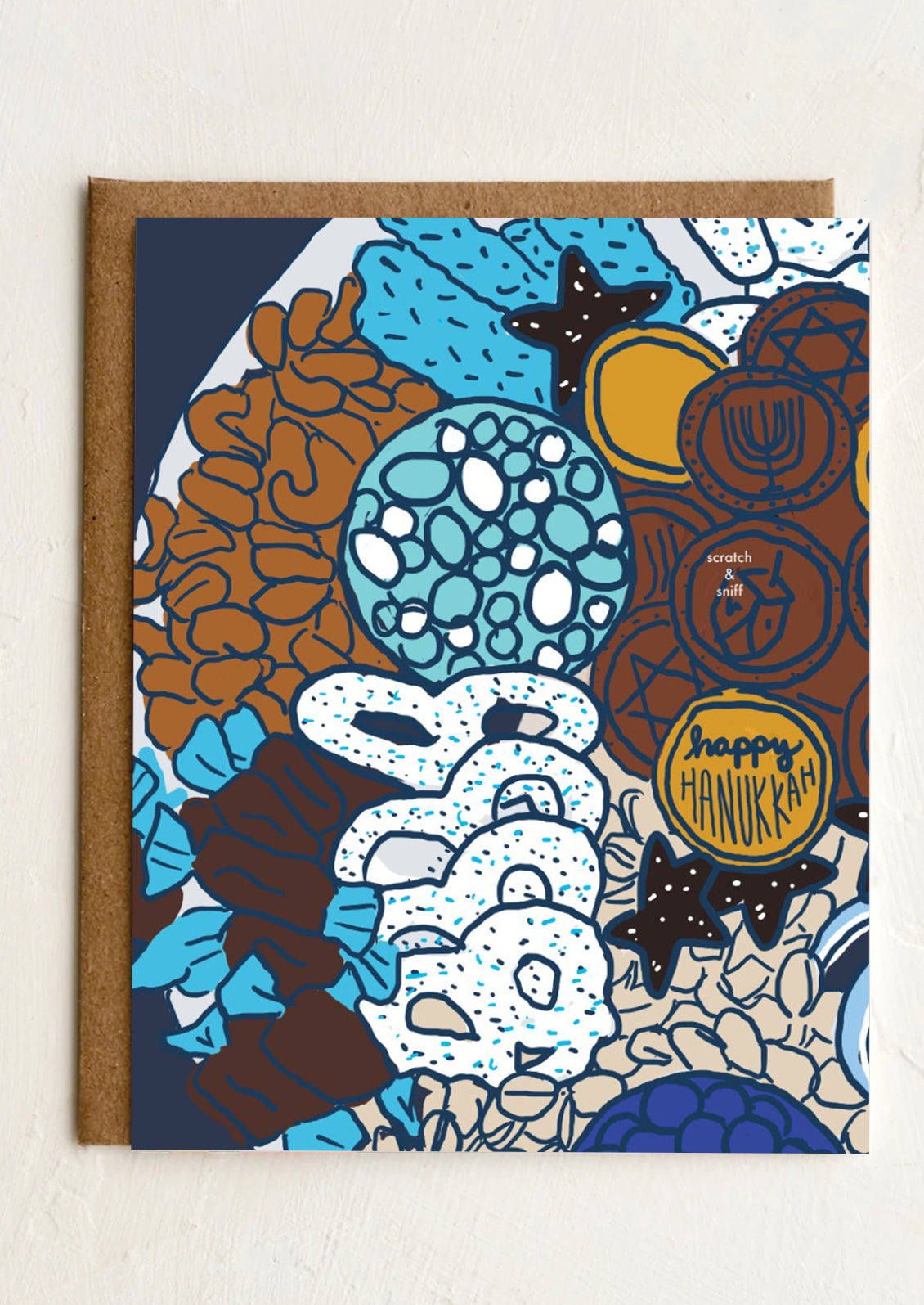 A greeting card with illustration of assorted nuts and chocolate, text reads "Happy Hanukkah".