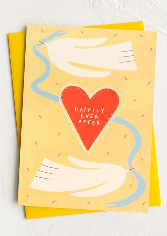 Card with a red heart and 'Happily Ever After' text on a yellow background