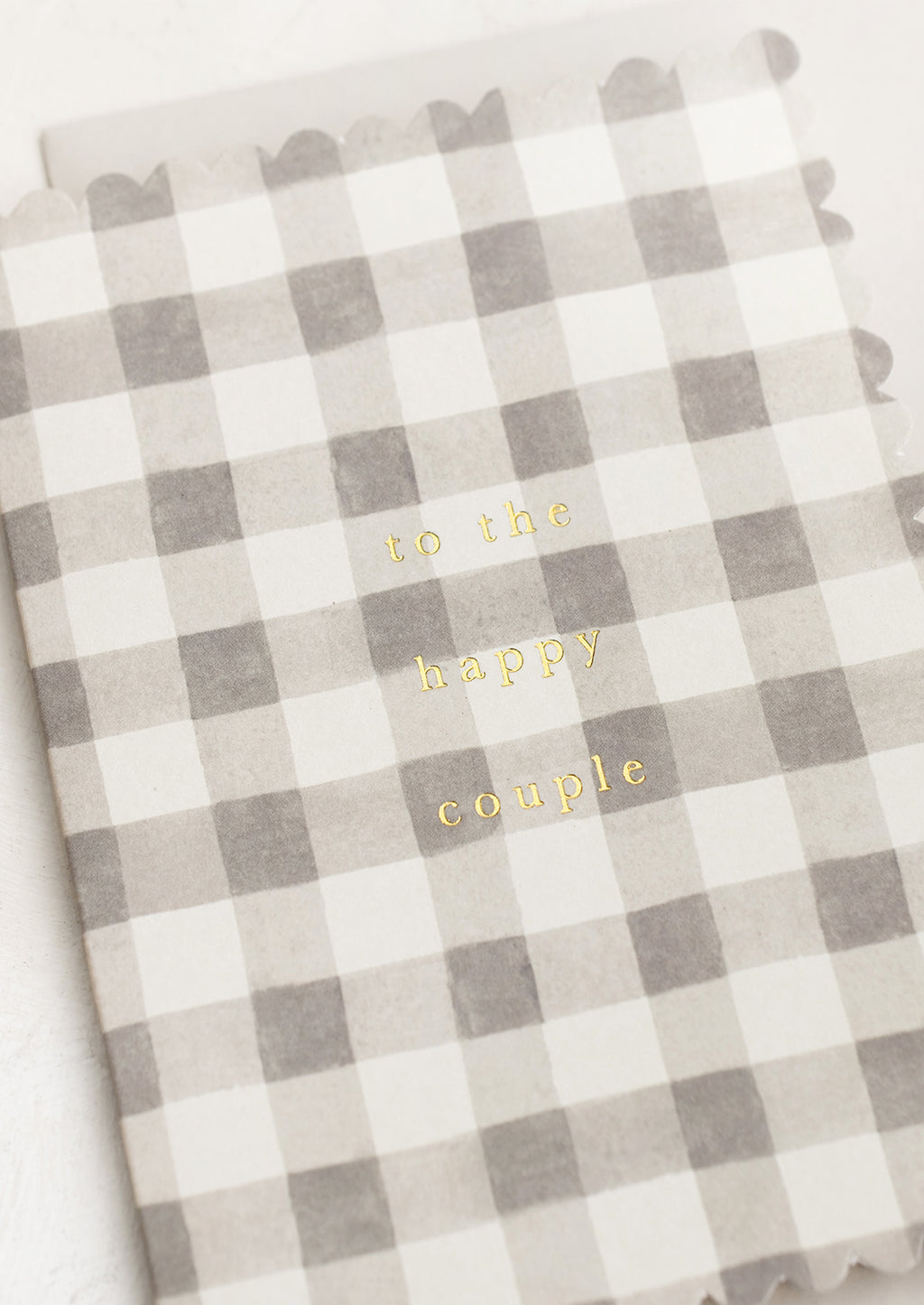 2: A scalloped edge card with grey gingham pattern reading "To the happy couple".