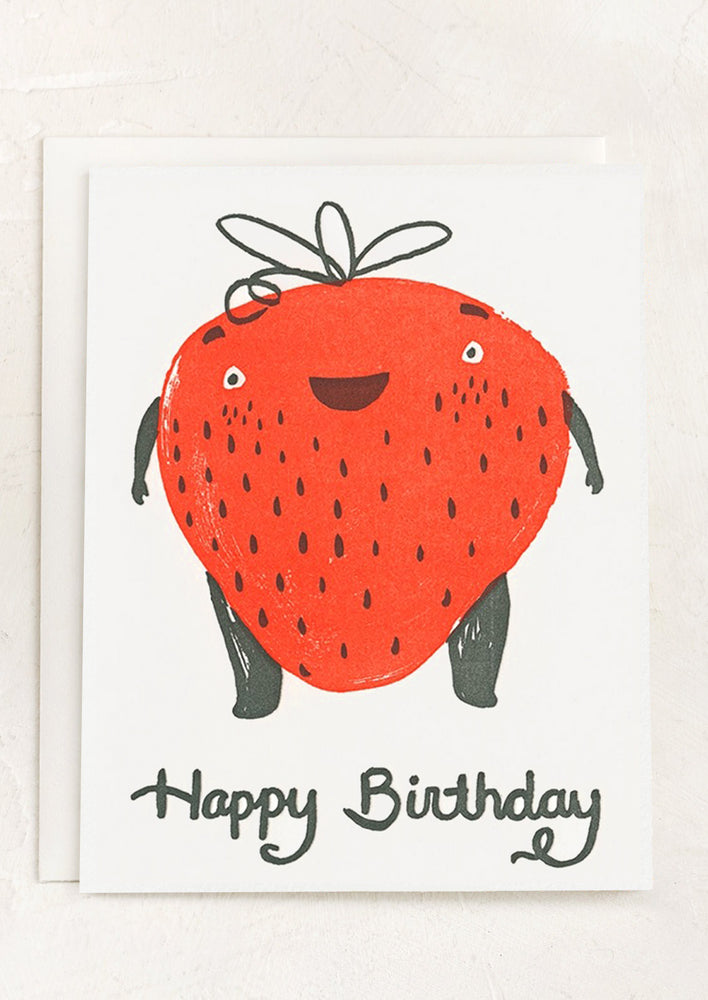 A card with illustration of giant smiling strawberry, text reads "Happy birthday".