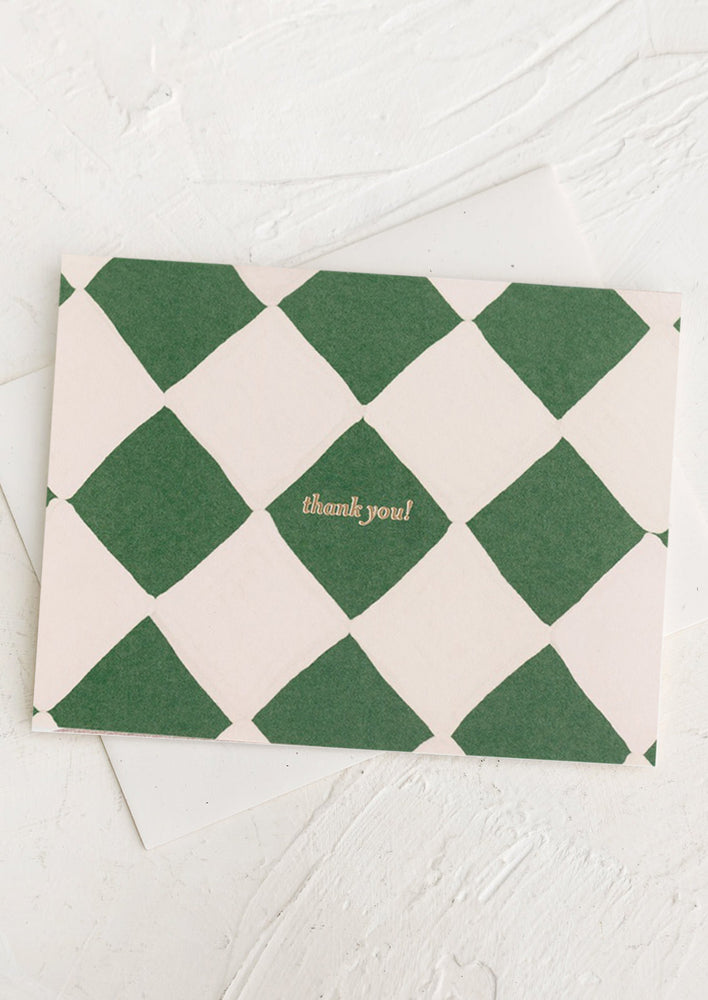 1: A green and ivory diamond print thank you card.