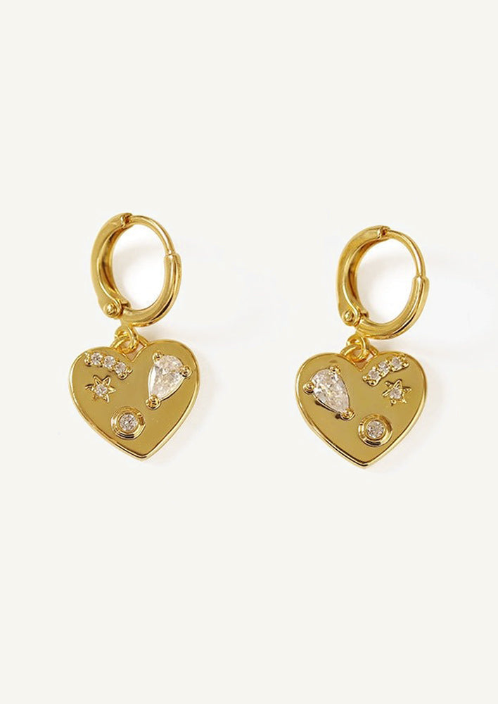 A pair of small huggie hoops with small heart charm with crystal embedding.