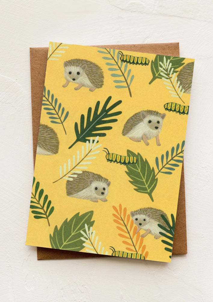 A yellow card with illustration of hedgehogs.