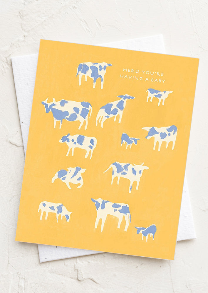A cow print card reading "Herd you're having a baby".
