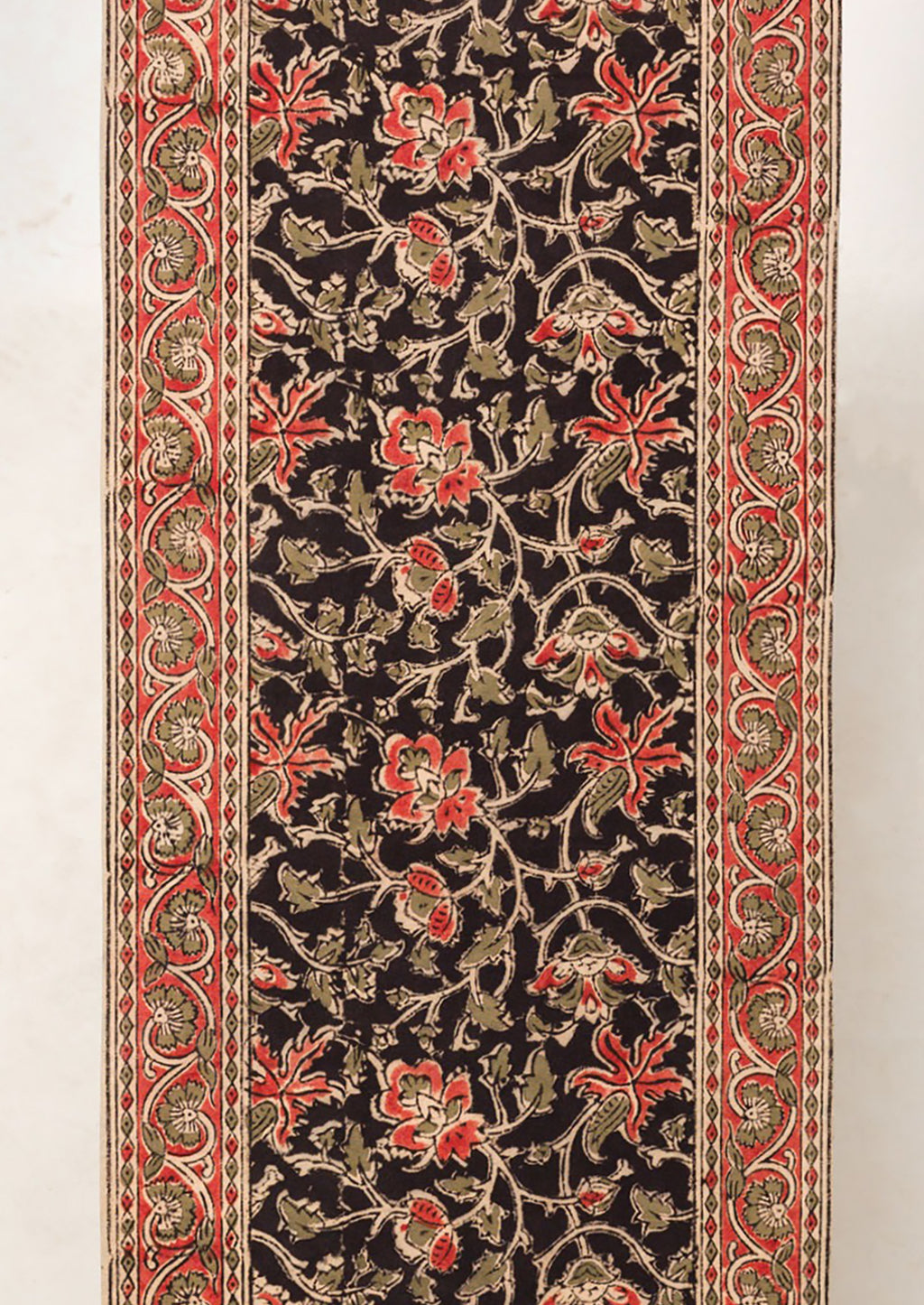 2: A table runner with black and red floral print.