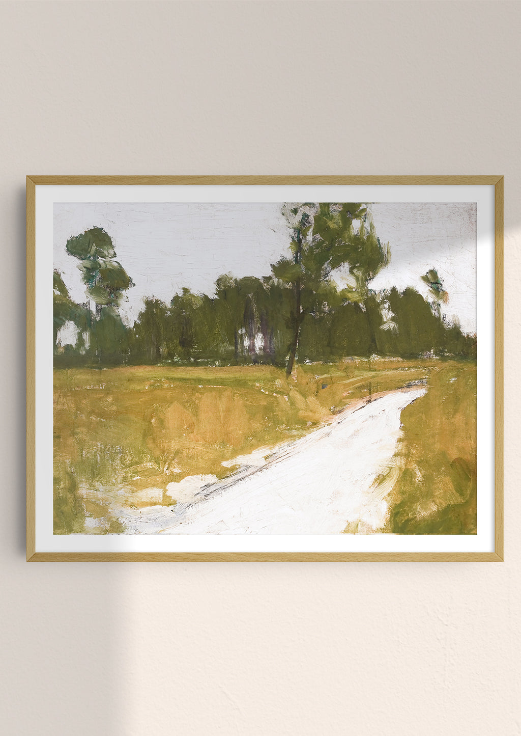 2: An art print of painting of road along the woods in frame.