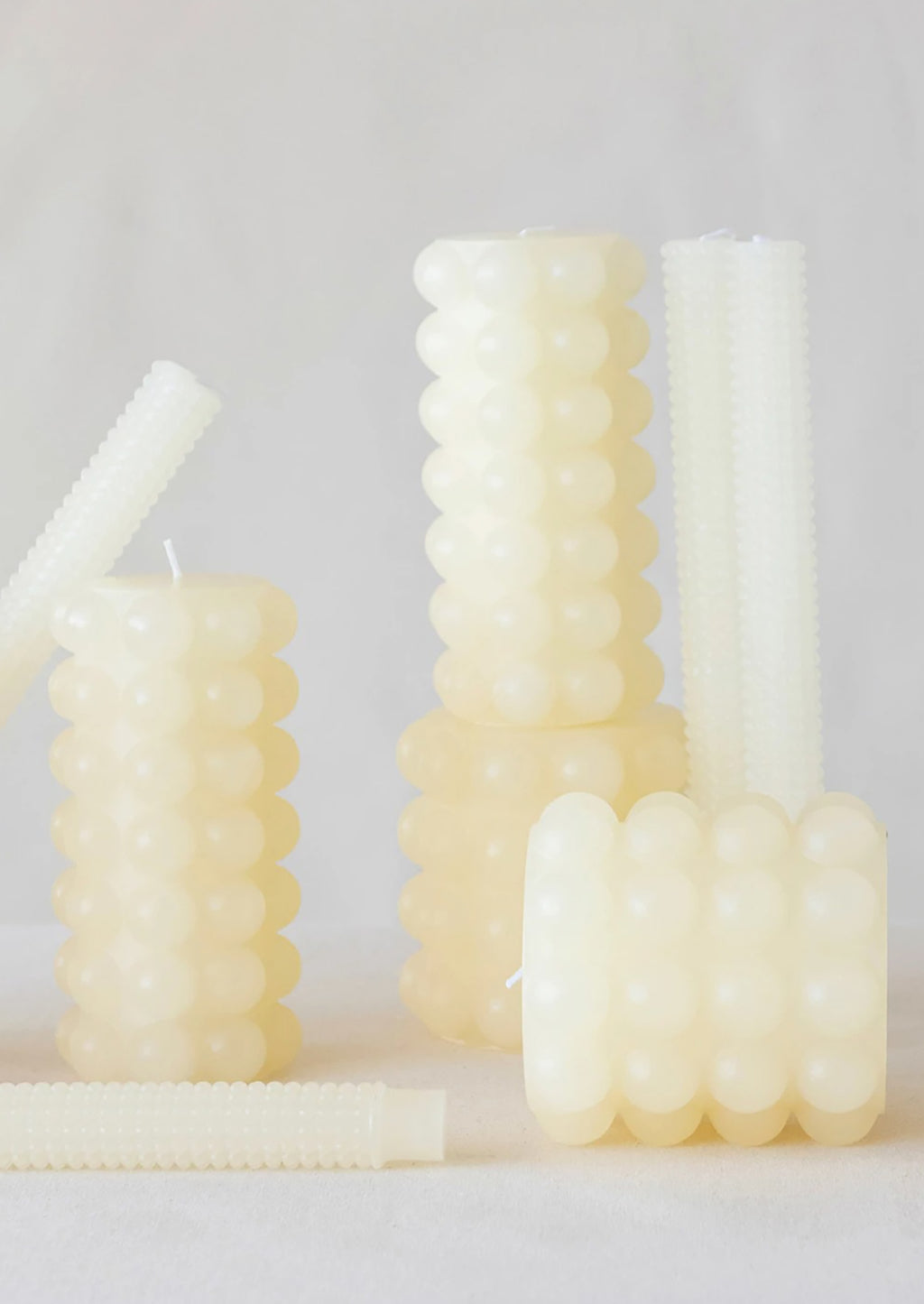 1: Assorted hobnail texture candles in buttermilk color.