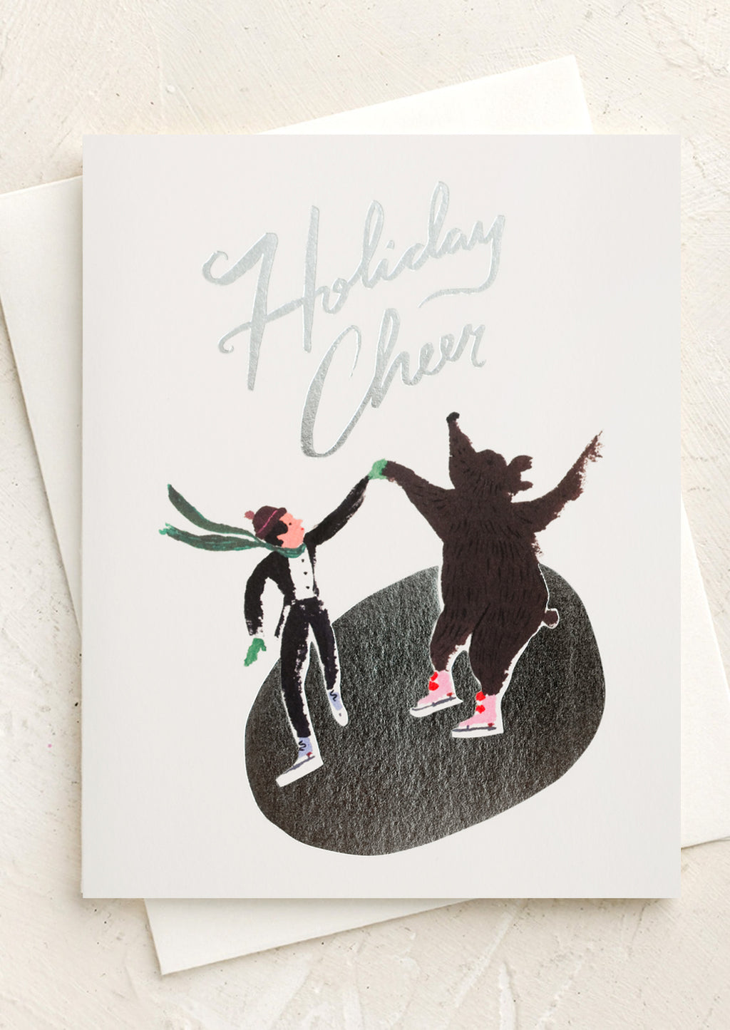 2: A set of cards depicting an ice skater and bear skating on silver pond, text reads "Holiday cheer".