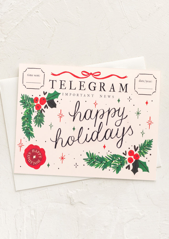 A holly print card reading "Happy Holidays" made to look like snail mail.