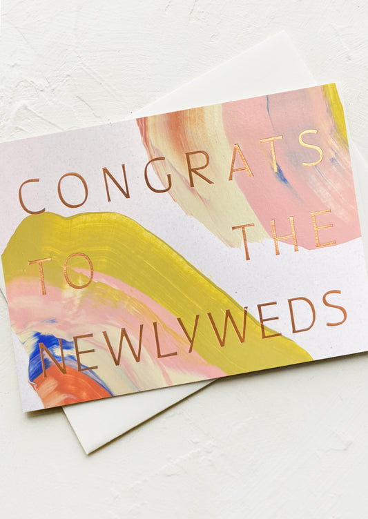 Greeting card with 'Congrats to the Newlyweds' text on a colorful abstract background