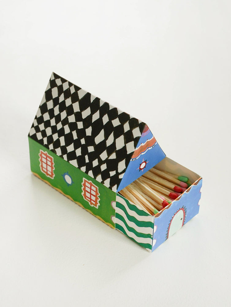 5: Two sides of a box of matches shaped like a house.