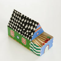 5: Two sides of a box of matches shaped like a house.