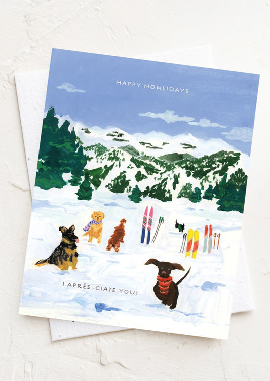 A card with illustration of dogs on a ski slope, text reads "Happy Howlidays, I Apres-Ciate You!"