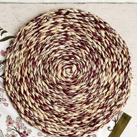 Raisin: A round woven raffia placemat in natural and raisin.