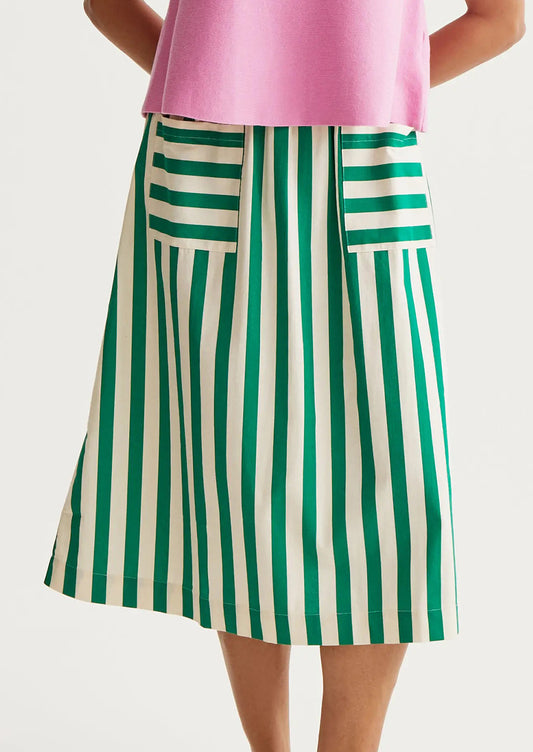 Green and white striped skirt worn by a person on a light gray background