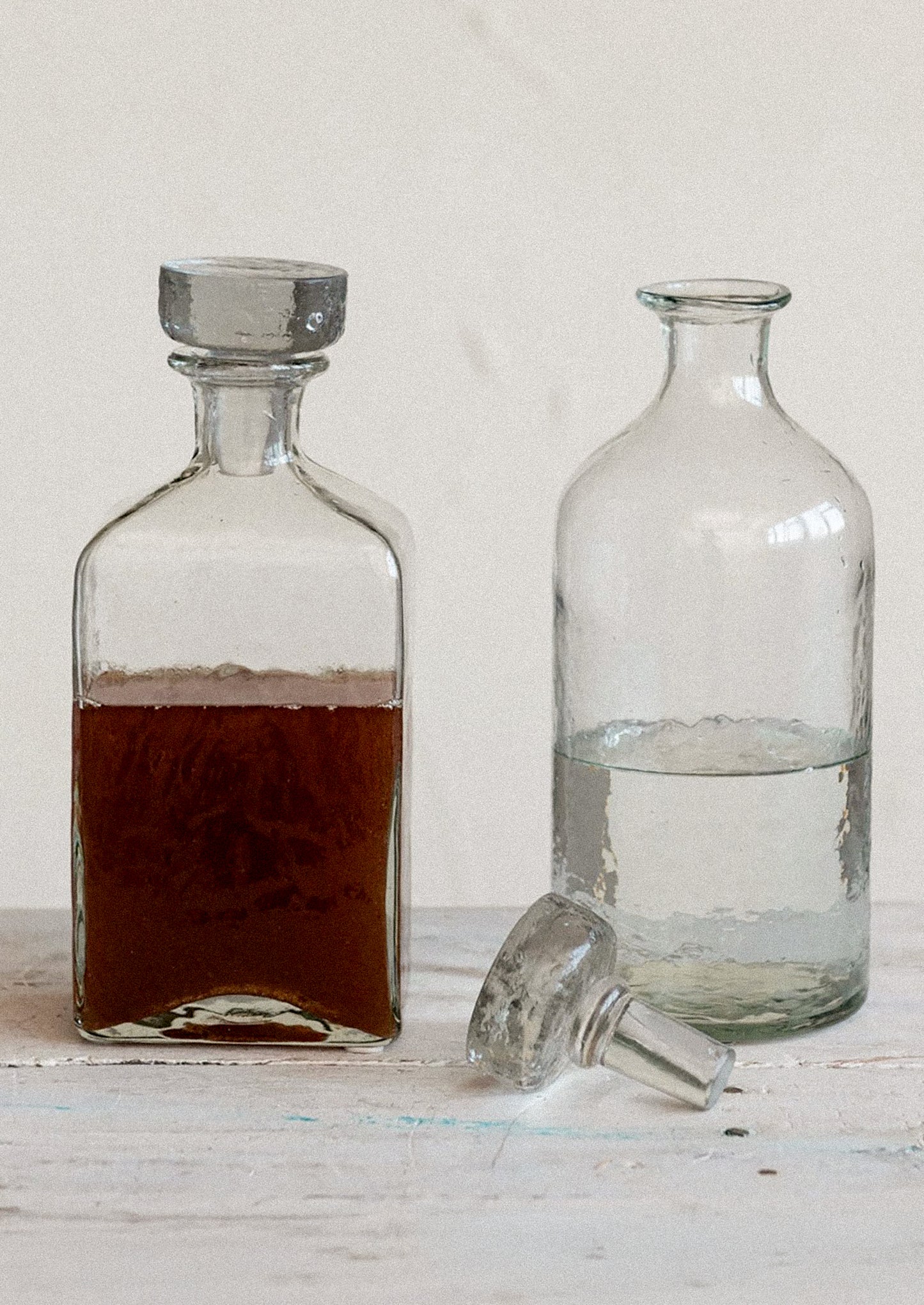 Decanters in clear glass with pebbled texture and glass stopper.
