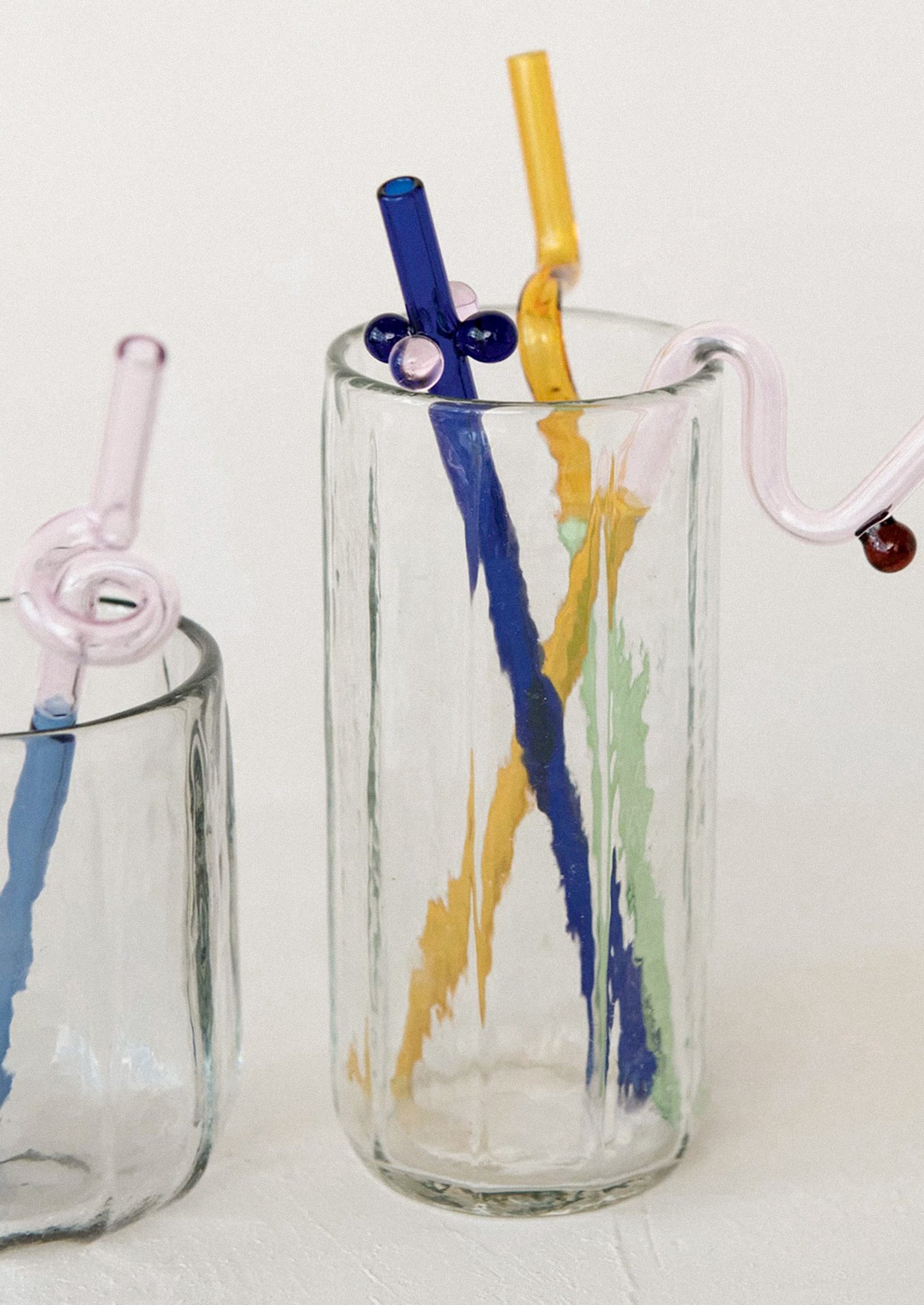 Two glass tumblers with colorful straws.