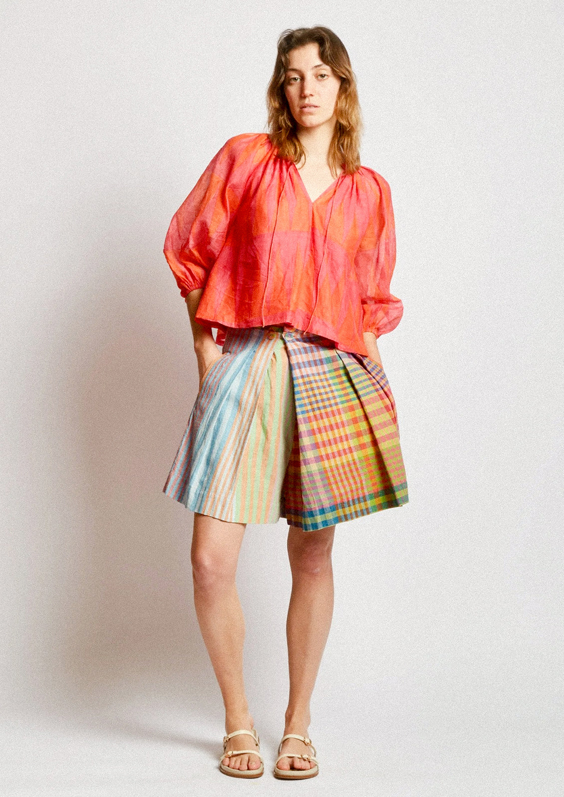 A person wearing a skort in colorful madras cotton.