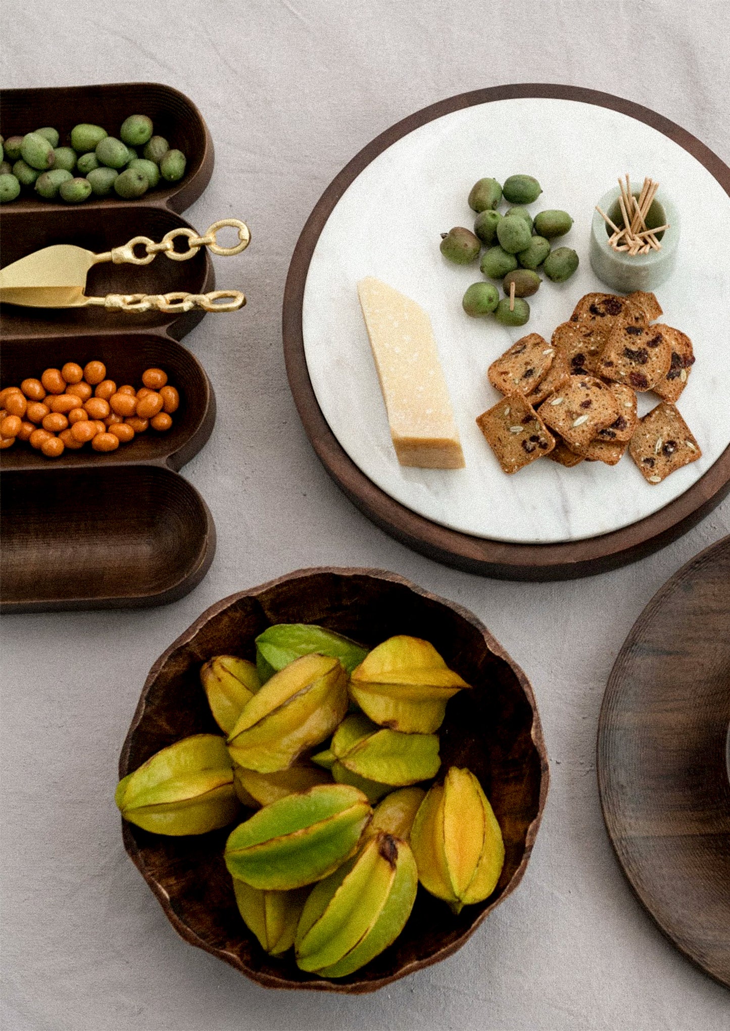 A dark wood serving vessel with four sections.