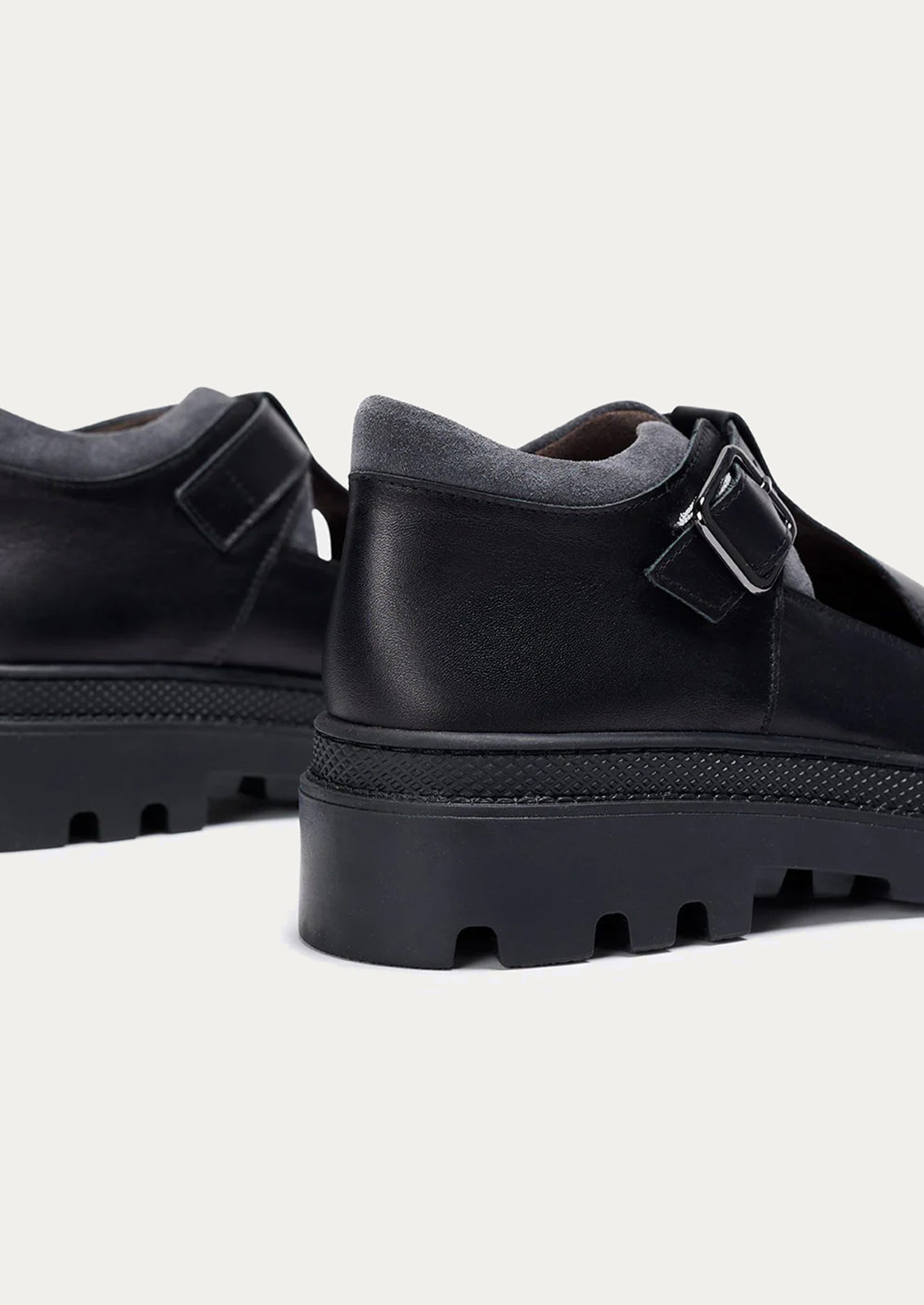 Black rubber shoes with thick sole on a white background