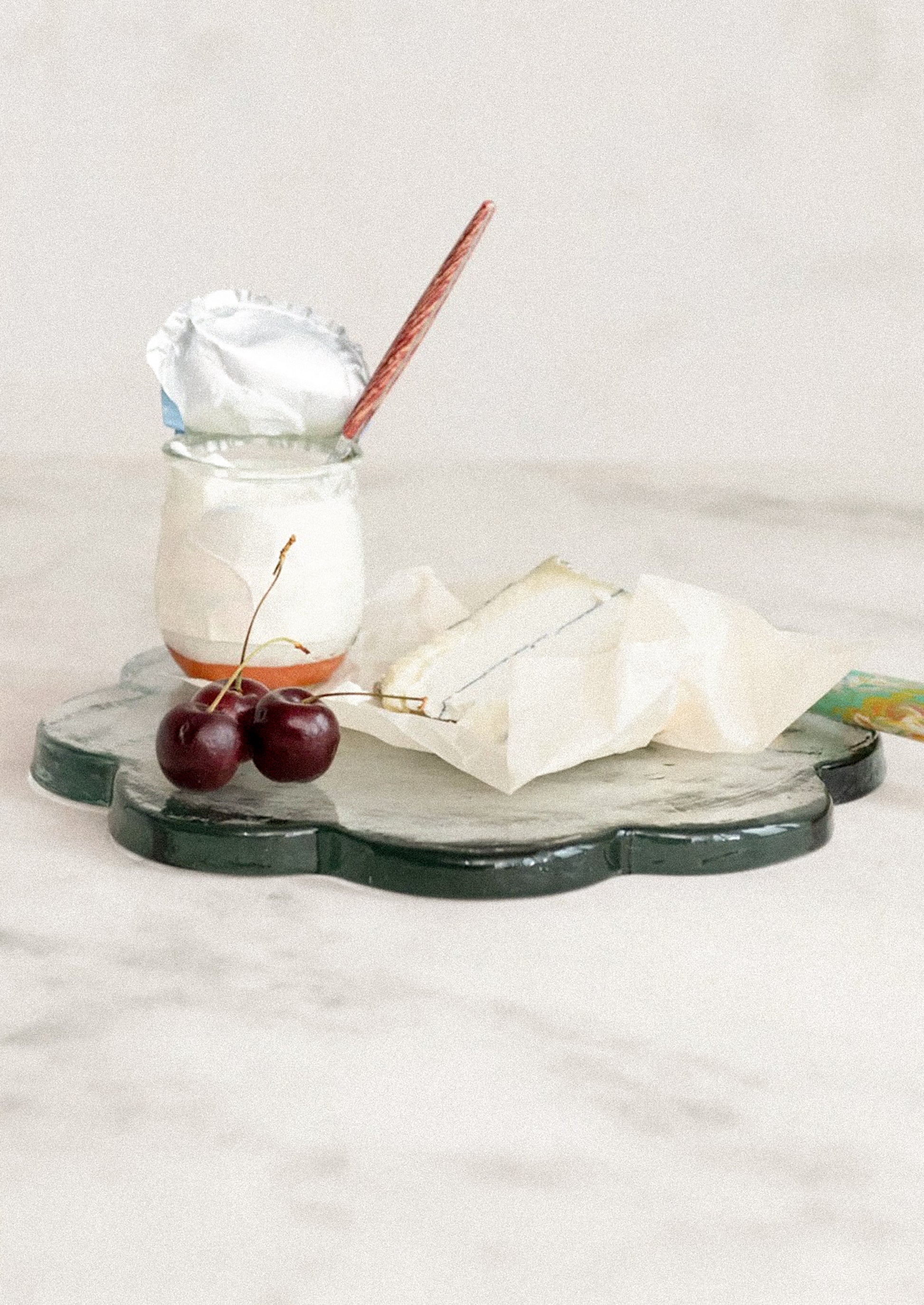 Flower-shaped glass tray with a textured surface.