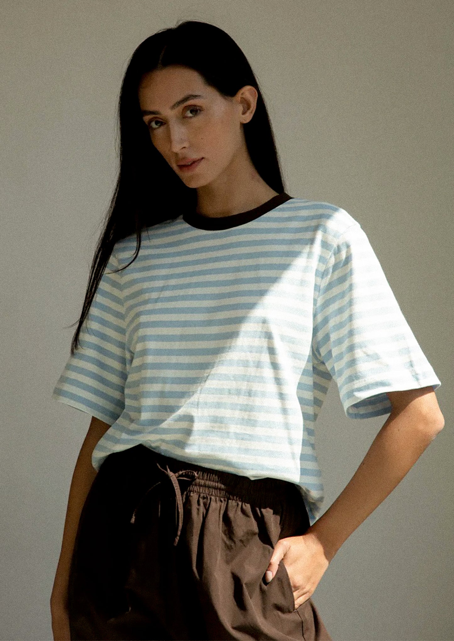 Striped shirt with brown and white horizontal stripes and red contrast collar.