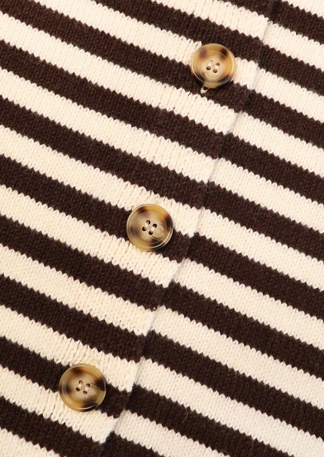 Close-up of a brown and white striped fabric with buttons