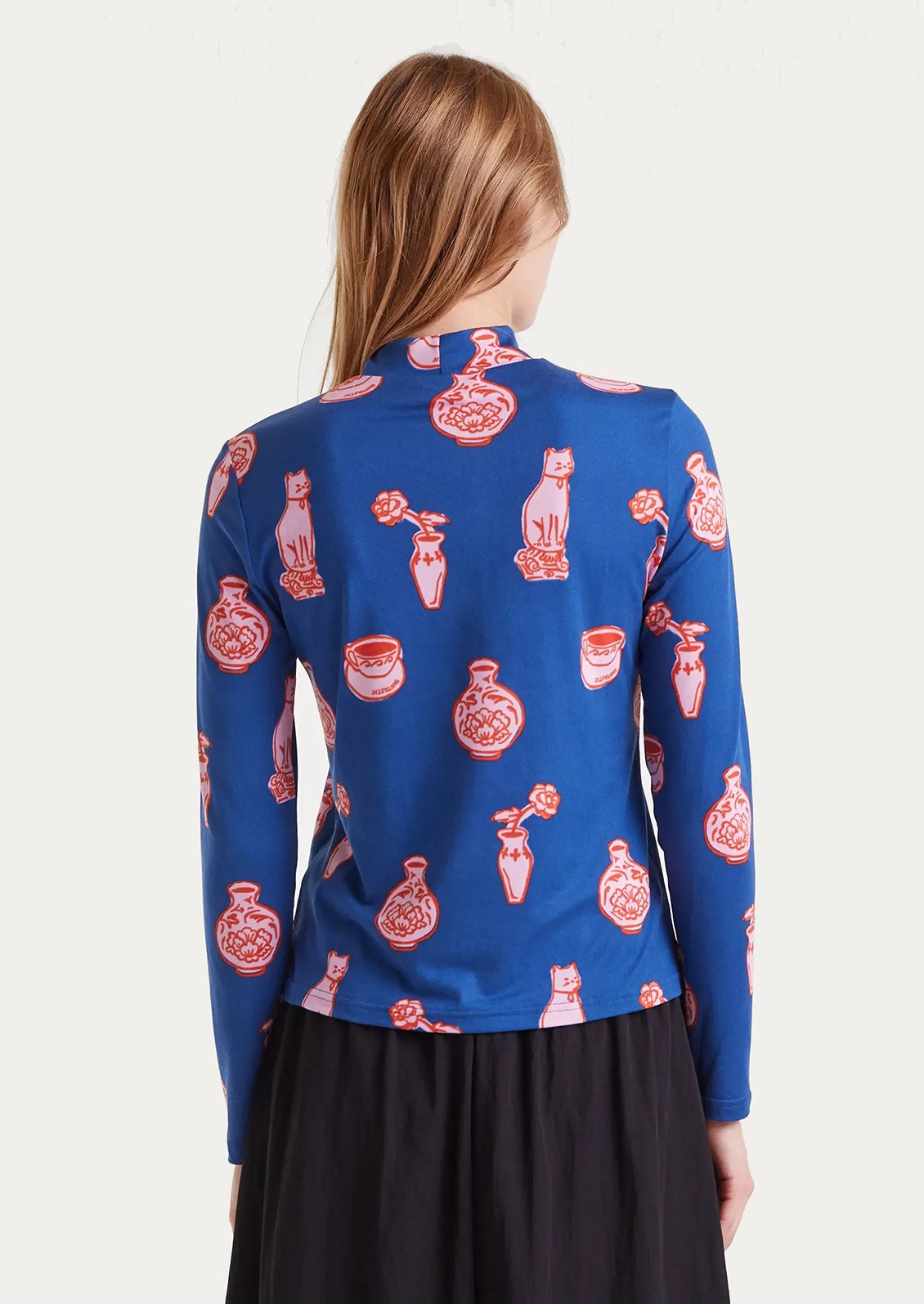 Blue long-sleeve shirt with red and pink ceramics pattern.