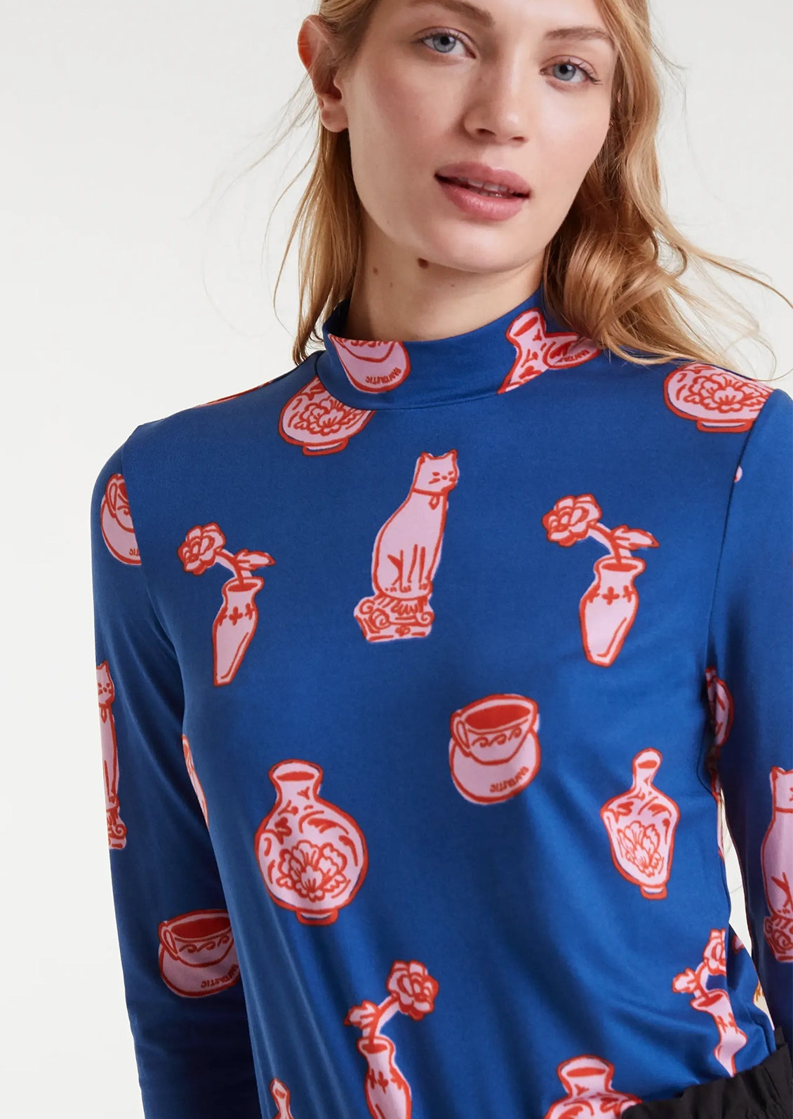Blue long-sleeve shirt with red and pink ceramics pattern.