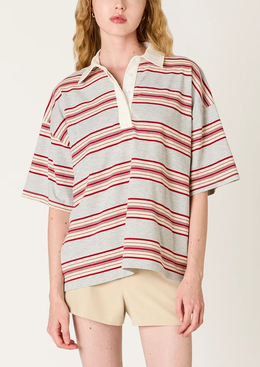 Person wearing a striped shirt with a plain background