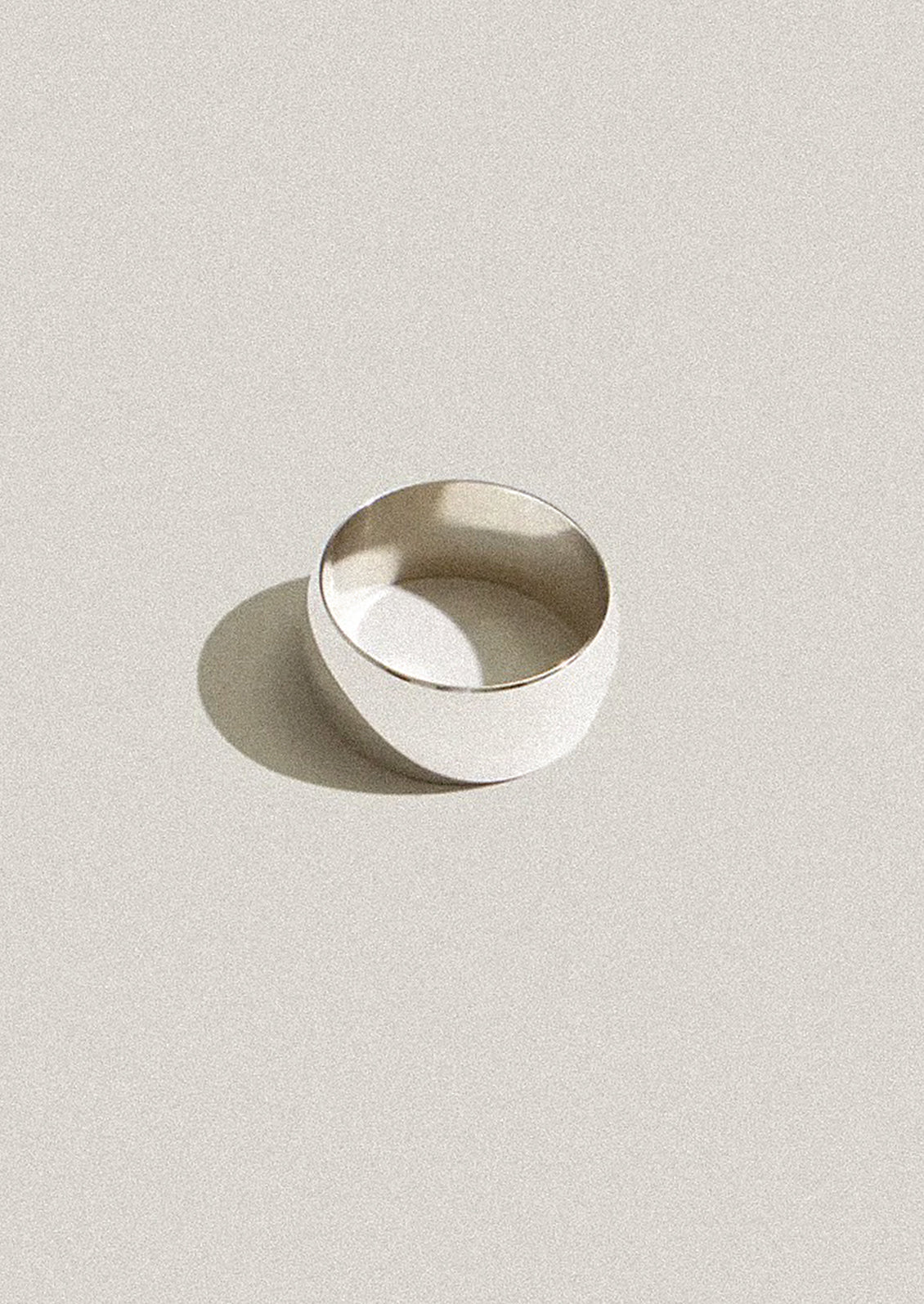Silver ring on a light gray background