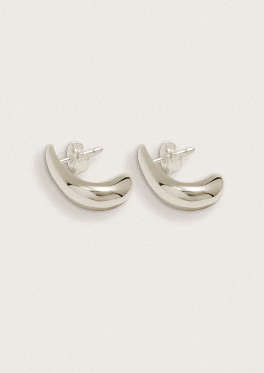 Silver earrings with a curved shape on a white background