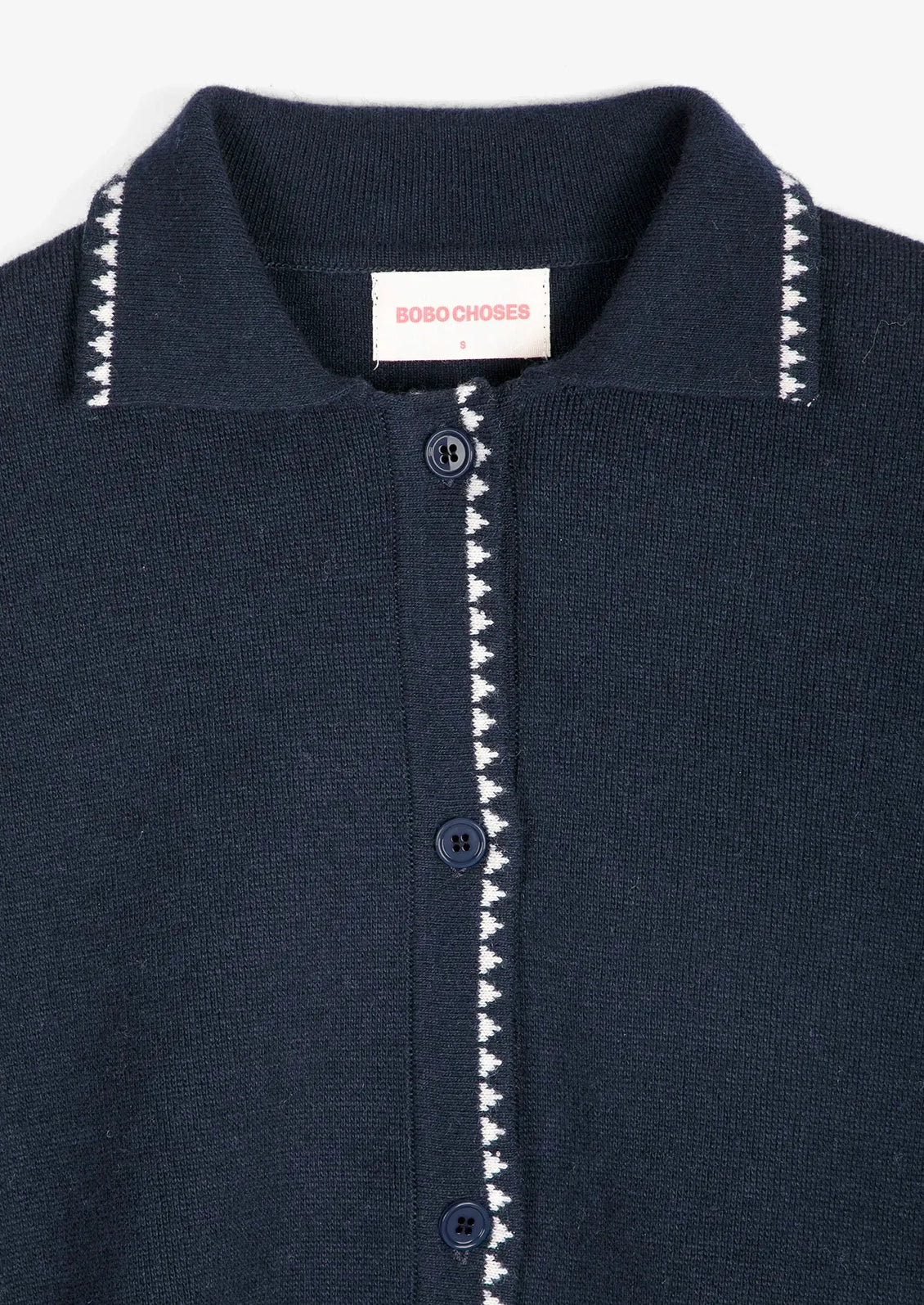 A navy blue cardigan with white trim detail.
