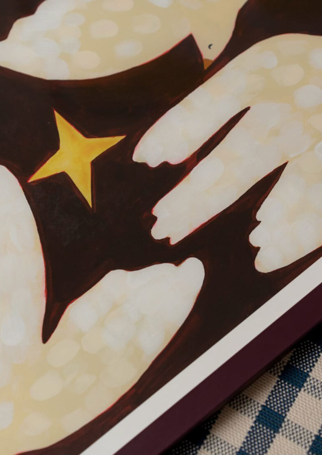 Close-up of a decorative item with hands and a star on a brown background