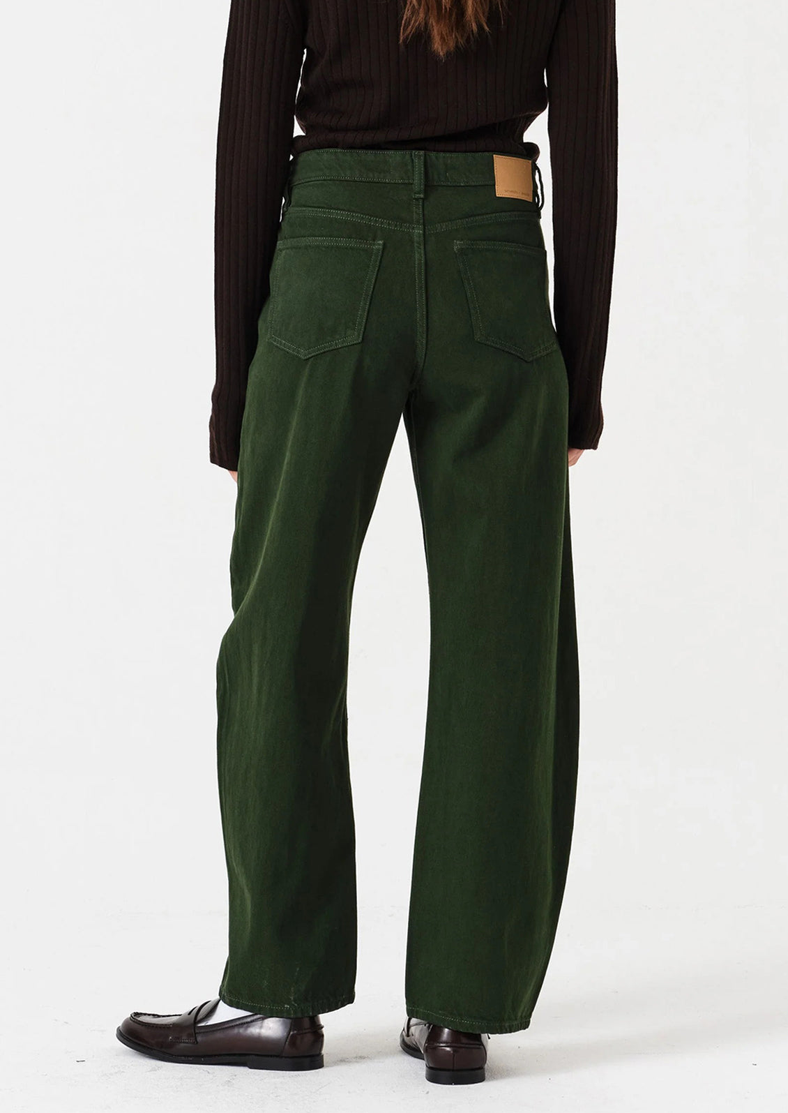 Person wearing green pants on a white background
