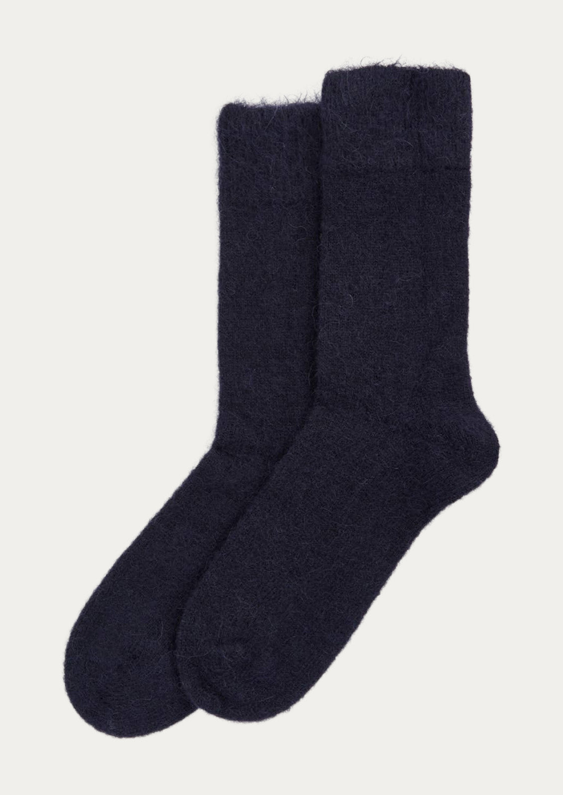 A pair of textured alpaca blend, calf-length socks in dark inky blue.