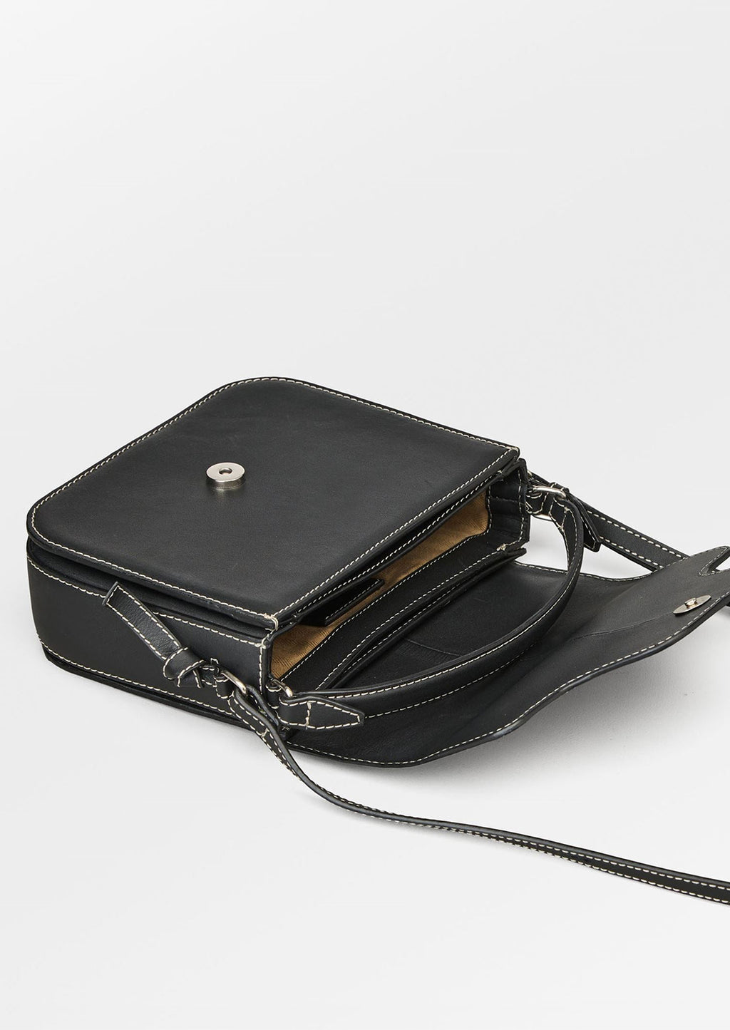 4: A leather handbag in black with white contrast stitching and flap front design.