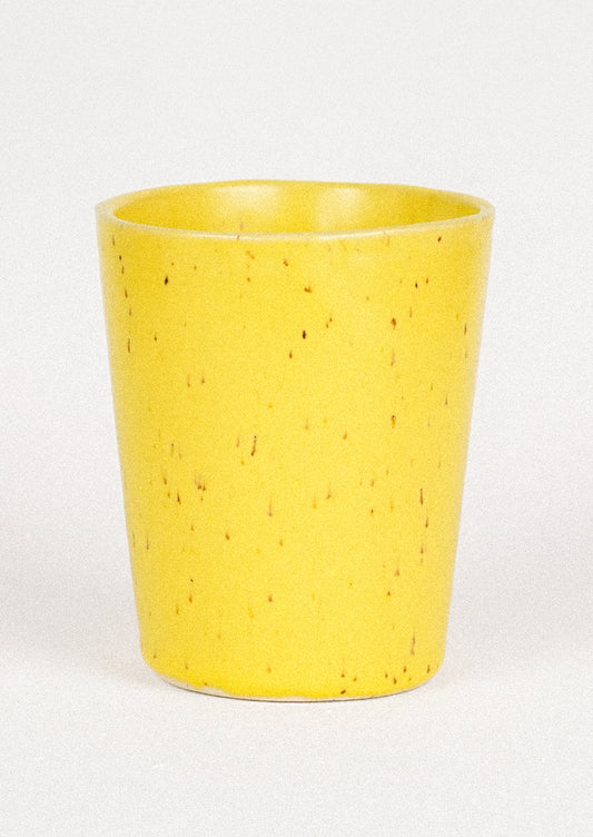 A 12oz ceramic cup in a speckled yellow color.