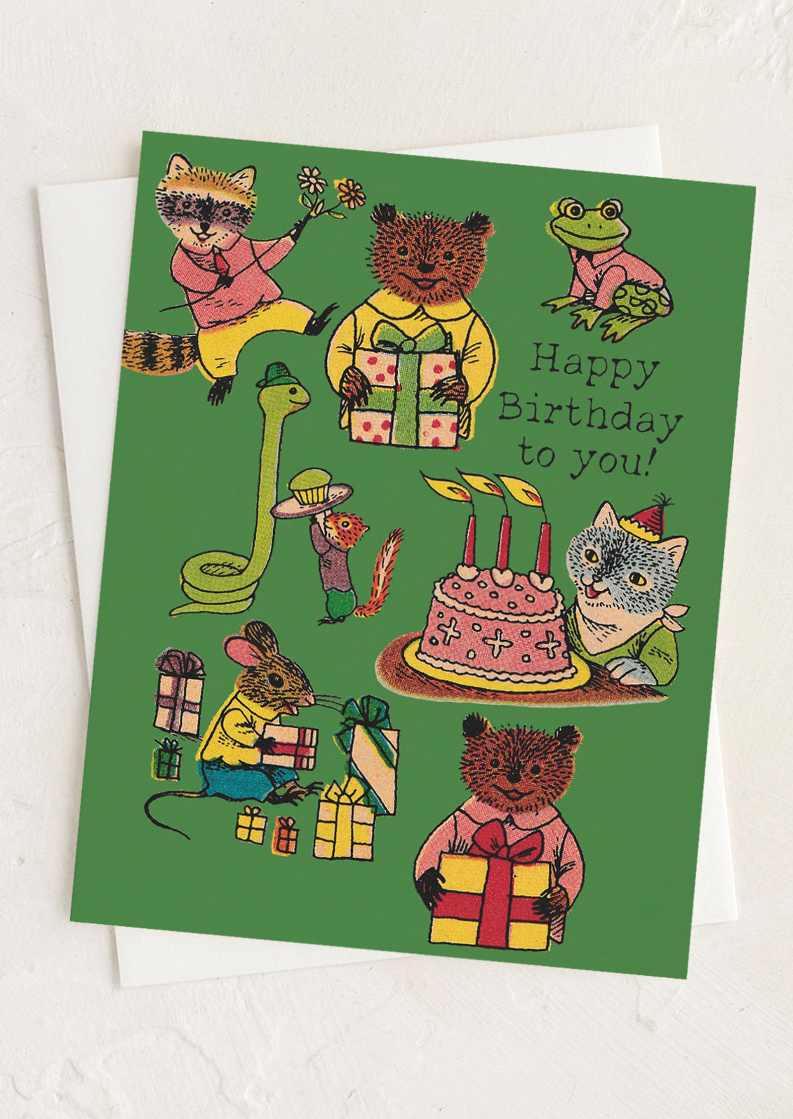 Birthday card with illustrated animals around a cake and presents on a green background