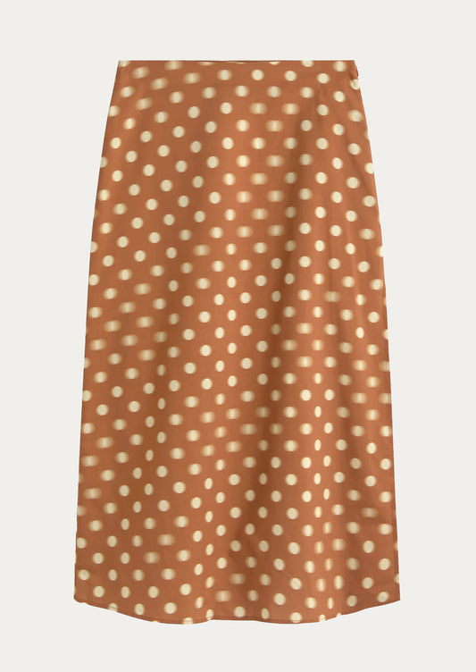 Brown skirt with white polka dot pattern on a light gray background