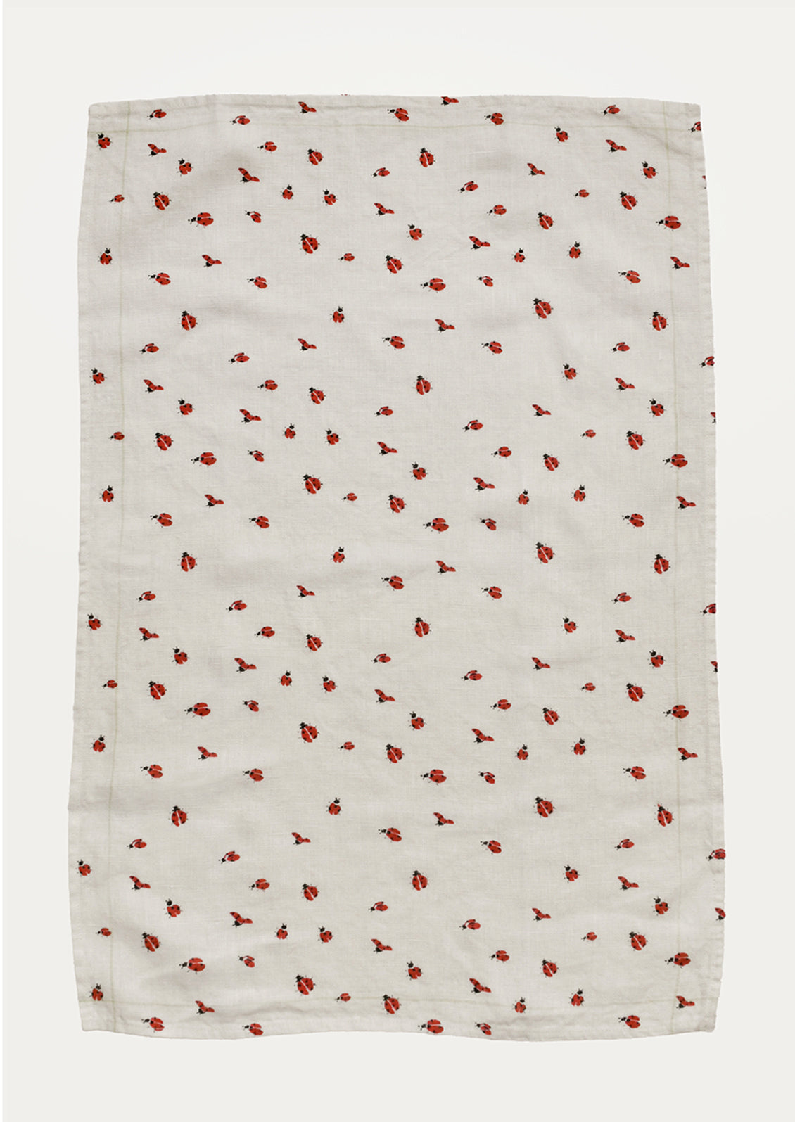 White towel with red ladybug pattern on a white background