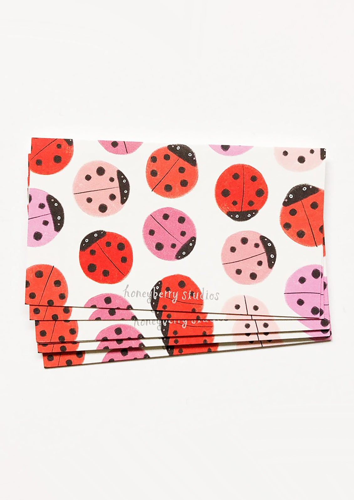Set of stationery items with ladybug pattern on a white background