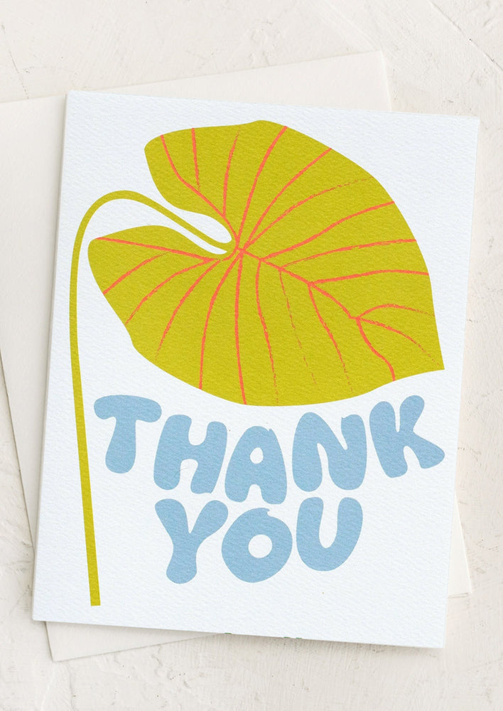 A card with giant neon leaf print, text reads "thank you".