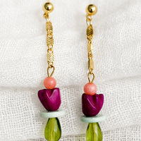 1: A pair of drop earrings with gold chain and beads.