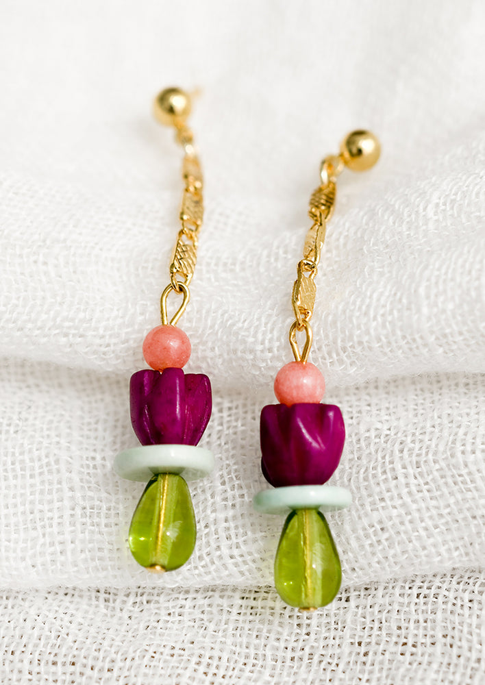 2: A pair of drop earrings with gold chain and beads.