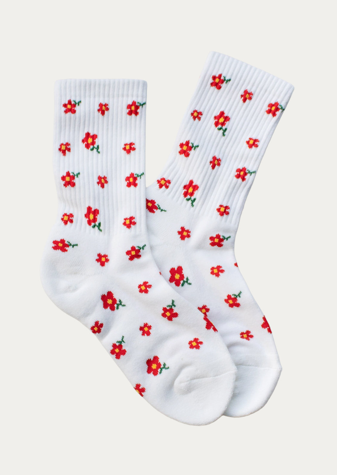 A pair of white ribbed crew socks with little red flowers throughout.