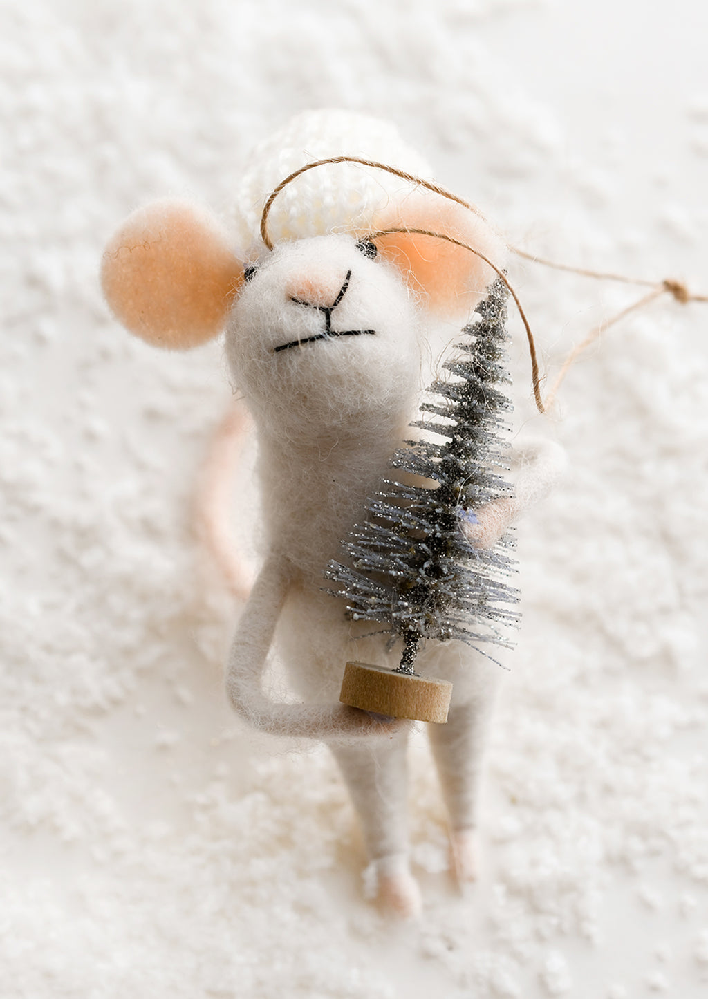 Knit Cap w/ Tree: A felted mouse ornament wearing white cap and holding silver tree.