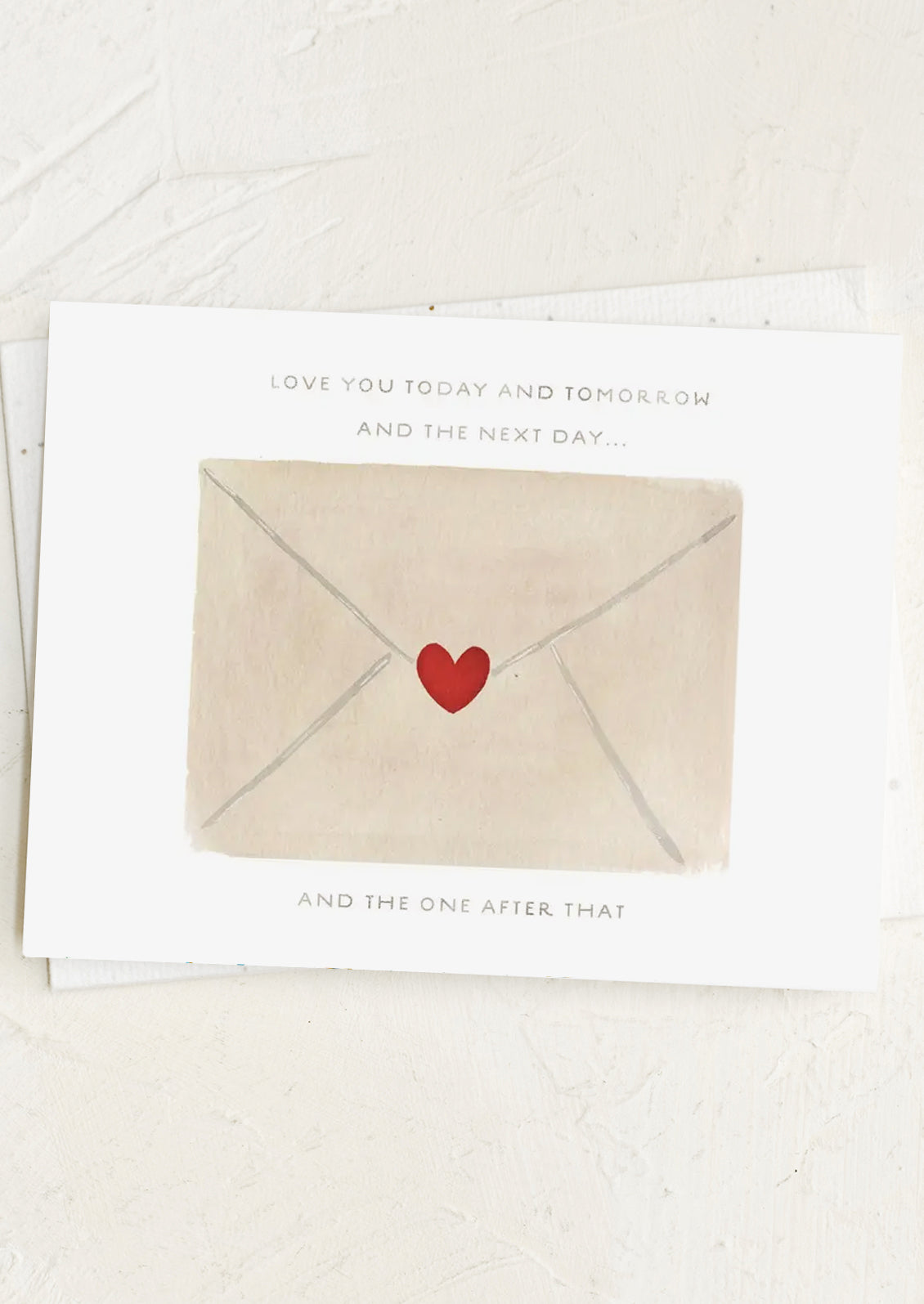 Card with a heart-shaped envelope and text on a white background