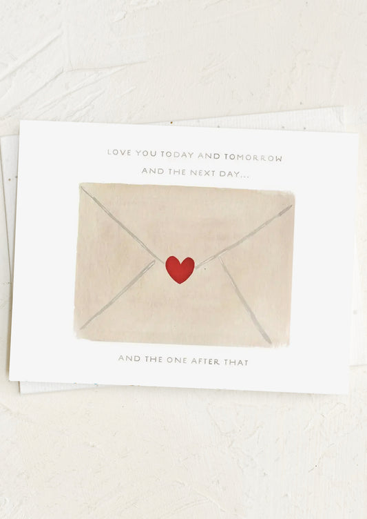Card with a heart-shaped envelope and text on a white background